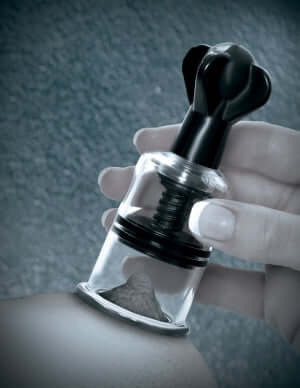 Hand using Fetish Fantasy Limited Edition Super Suckers Black for nipple suction.
