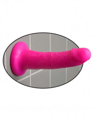 Dillio 6 inches slim pink dildo with suction cup base attached to flat surface for versatile pleasure options