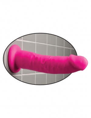 Pink Dillio 9-inch Dildo with suction cup base attached to a tiled wall