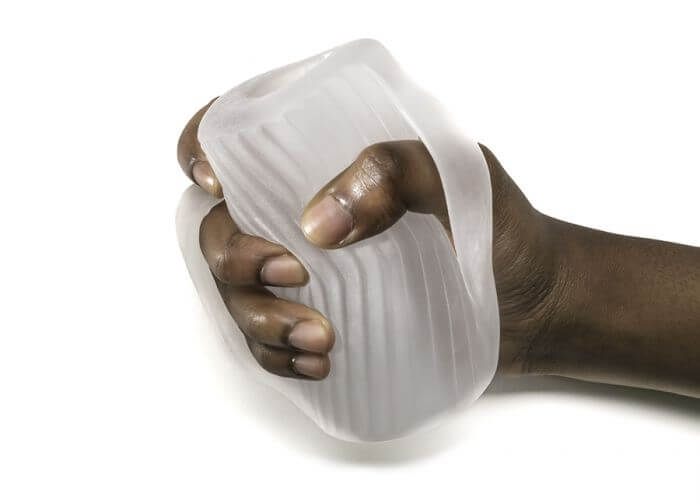 Perfect Fit Male Masturbator with ribs and nubs held in hand for ultimate pleasure experience