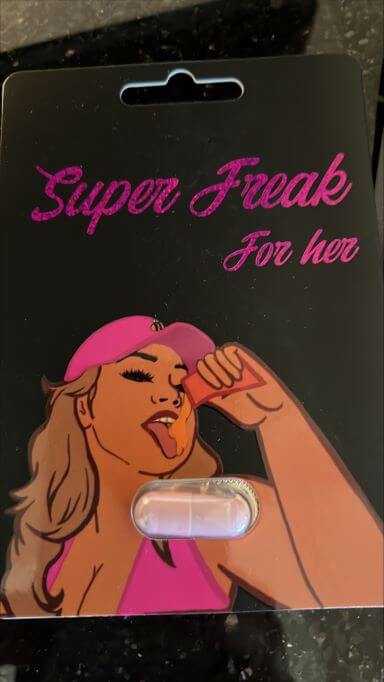 Super Freak For Her herbal supplement packaging featuring a woman and a capsule, promoting vitality and stamina.